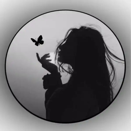 Silhouette of a person with long hair and a butterfly on a circular background