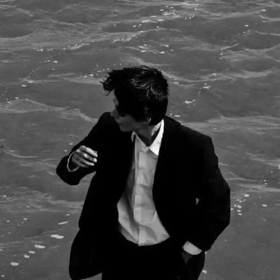 Person in a suit standing on a textured surface